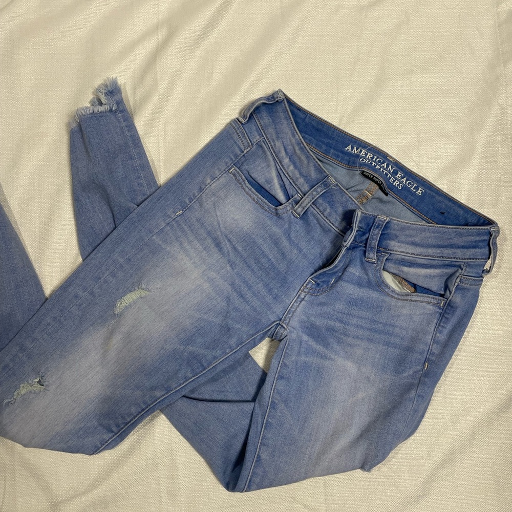 American Eagle super stretch super low jean jeggings rips ankle fringe size 4